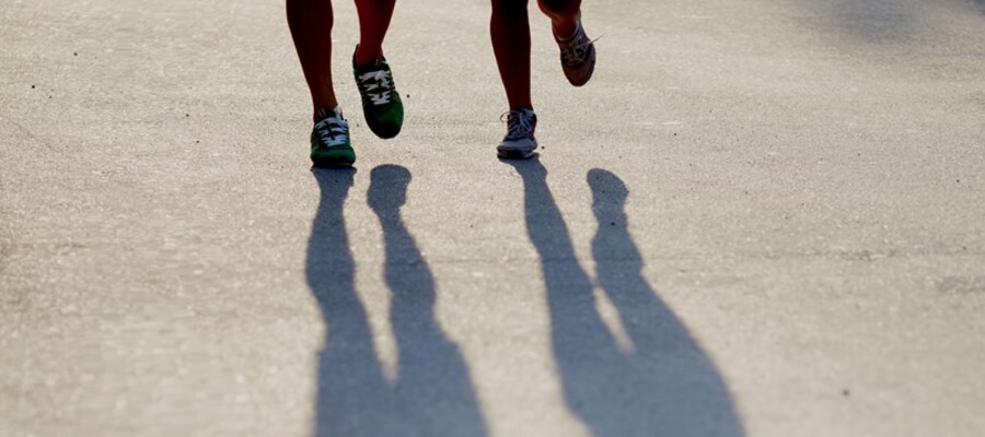 Two people running next to each other