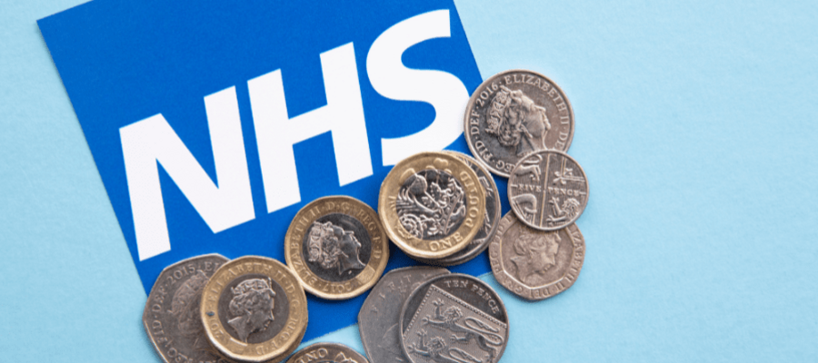 NHS badge with pound coins